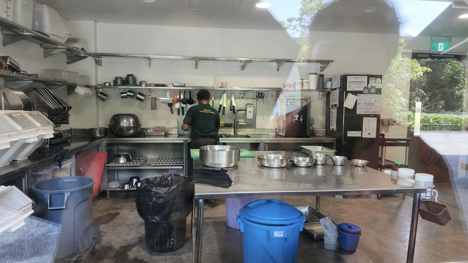 A keeper and work surfaces in the food preparation room, seen through glass